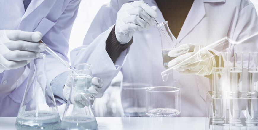 Researcher with glass laboratory chemical test tubes with liquid